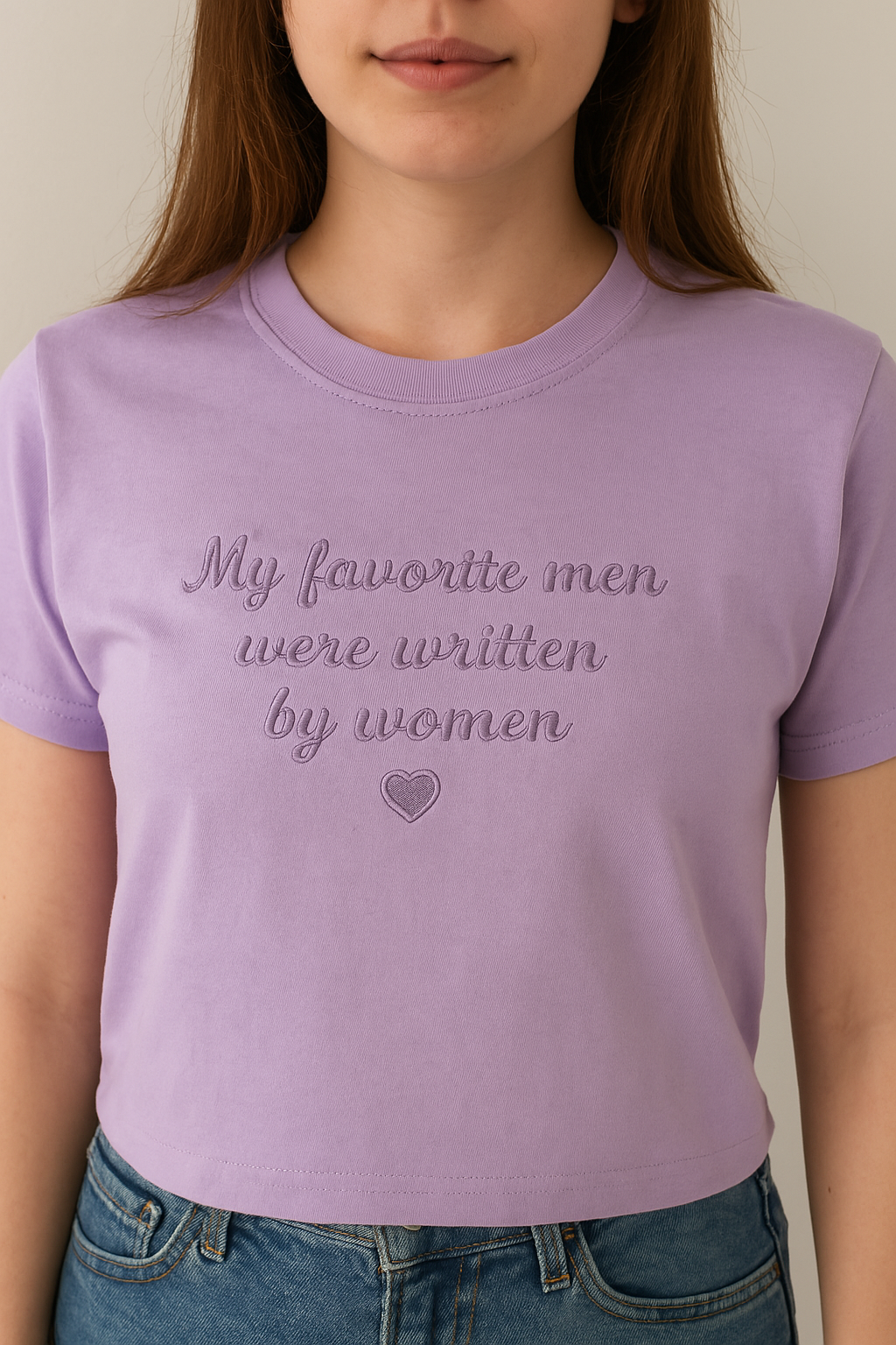a woman wearing a purple shirt that says, my favorite men were written by women