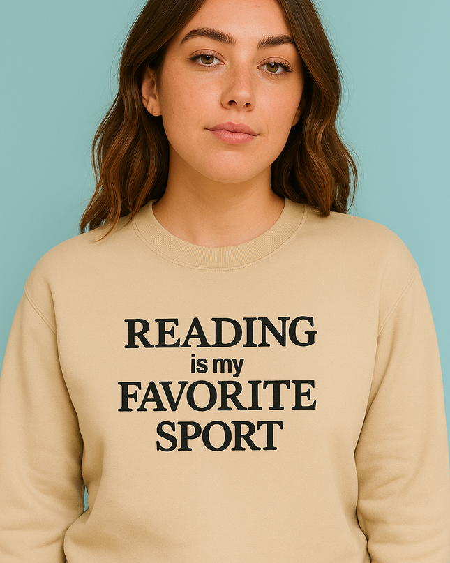 A woman wearing a beige sweater with the text "READING is my FAVORITE SPORT" printed on it.