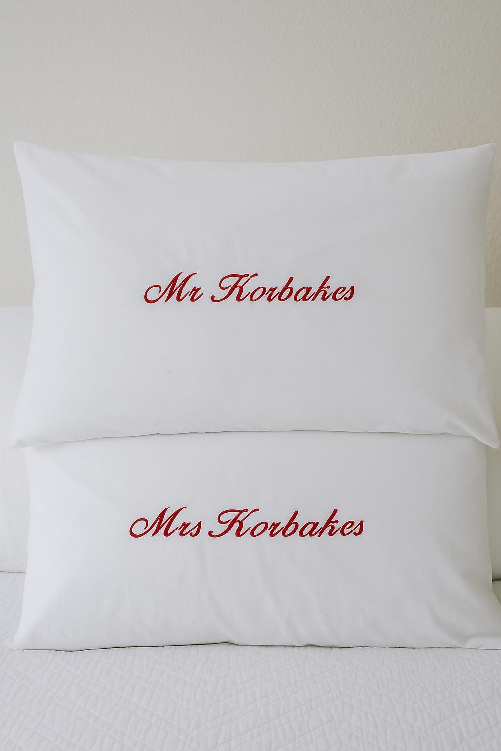 a couple of pillows sitting on top of a bed