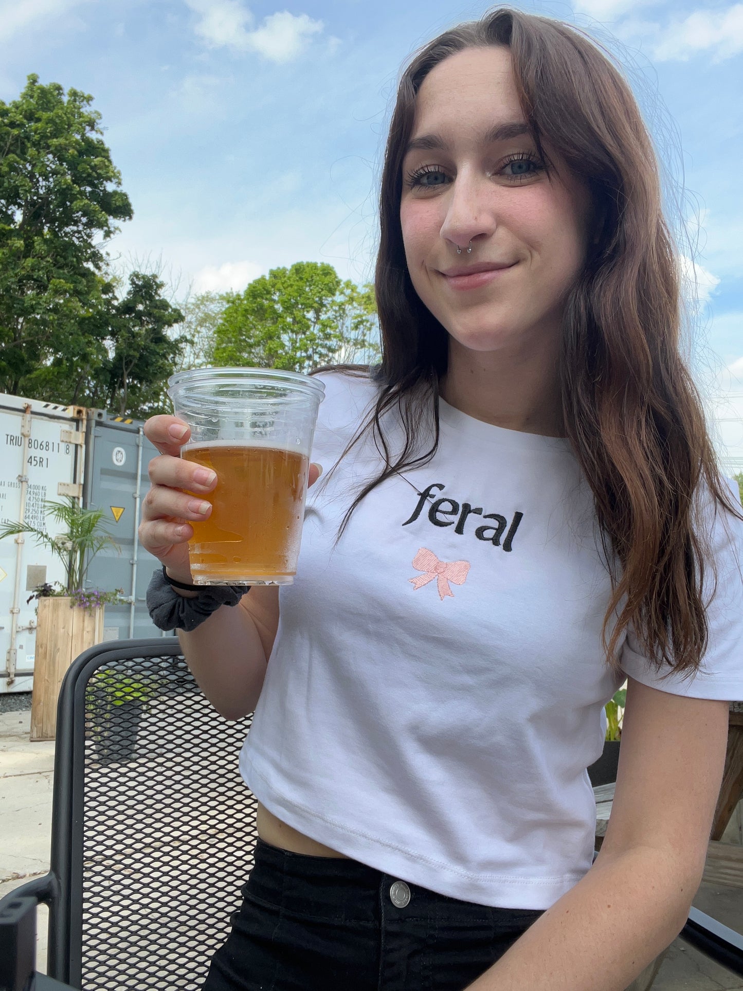 a woman holding a glass of beer in her hand