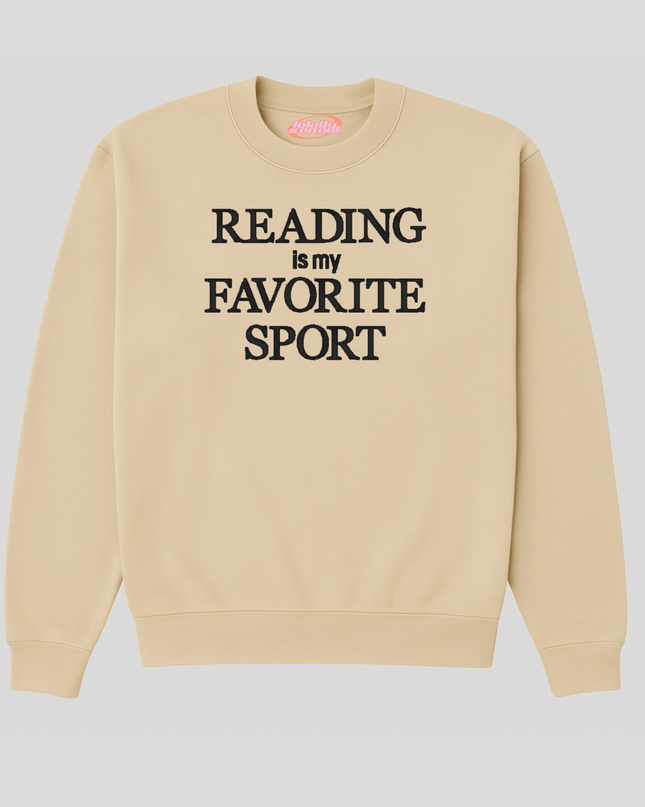 A beige sweatshirt with the text "READING is my FAVORITE SPORT" printed on it.
