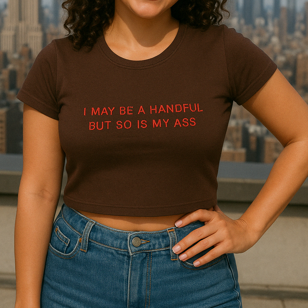 a woman wearing a brown shirt with a message on it