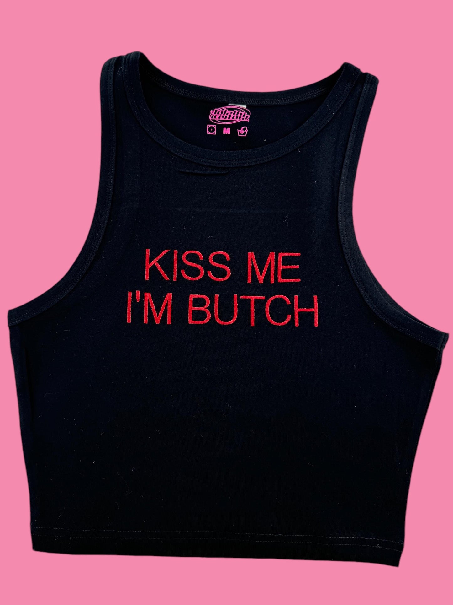 a black tank top that says kiss me i'm butch