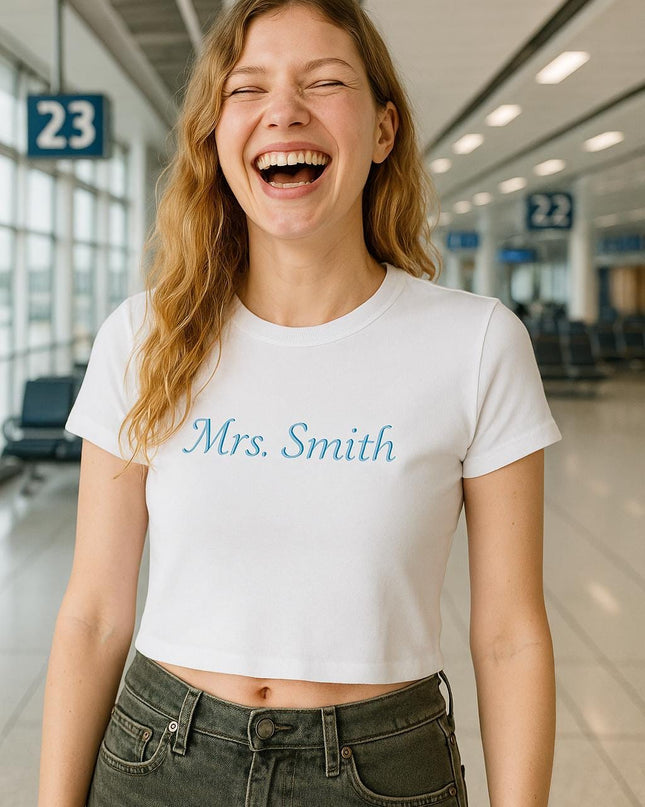 a woman laughing while standing in an airport