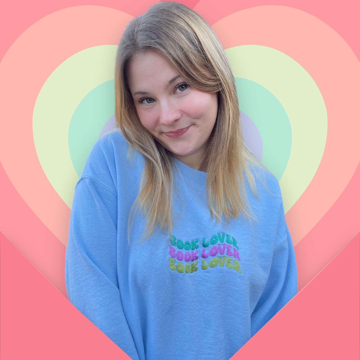 a woman with blonde hair wearing a blue shirt