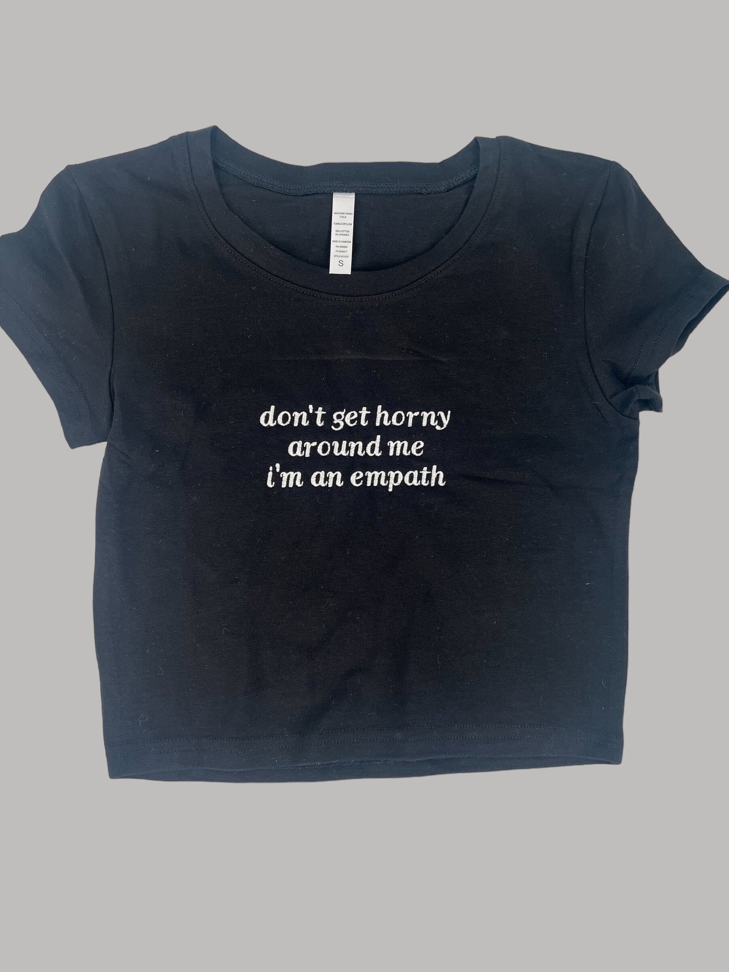 a black t - shirt with the words don't get horny, stand