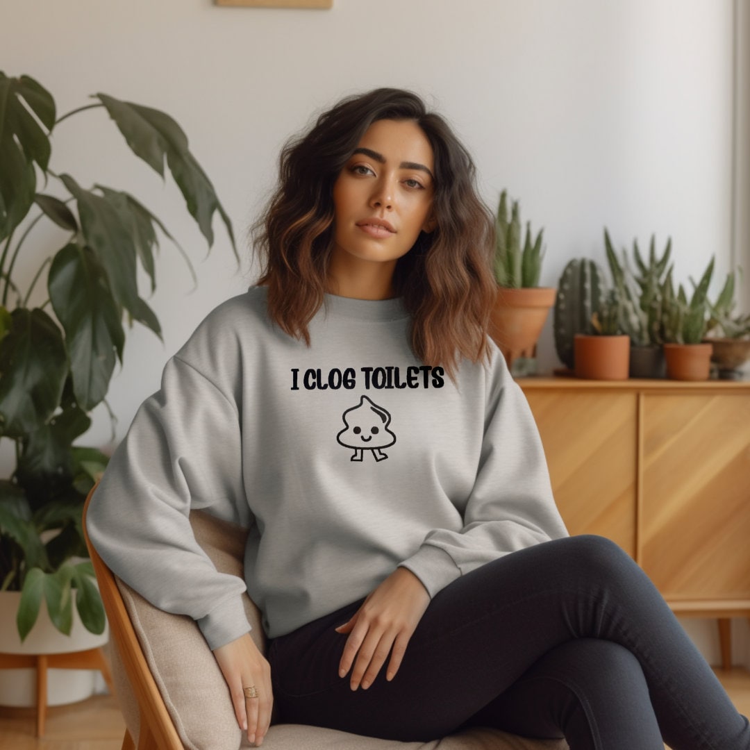 a woman sitting on a chair wearing a sweatshirt