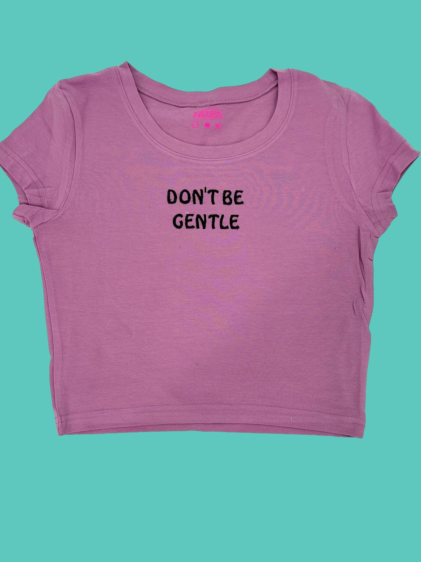 a pink shirt that says don't be gentle