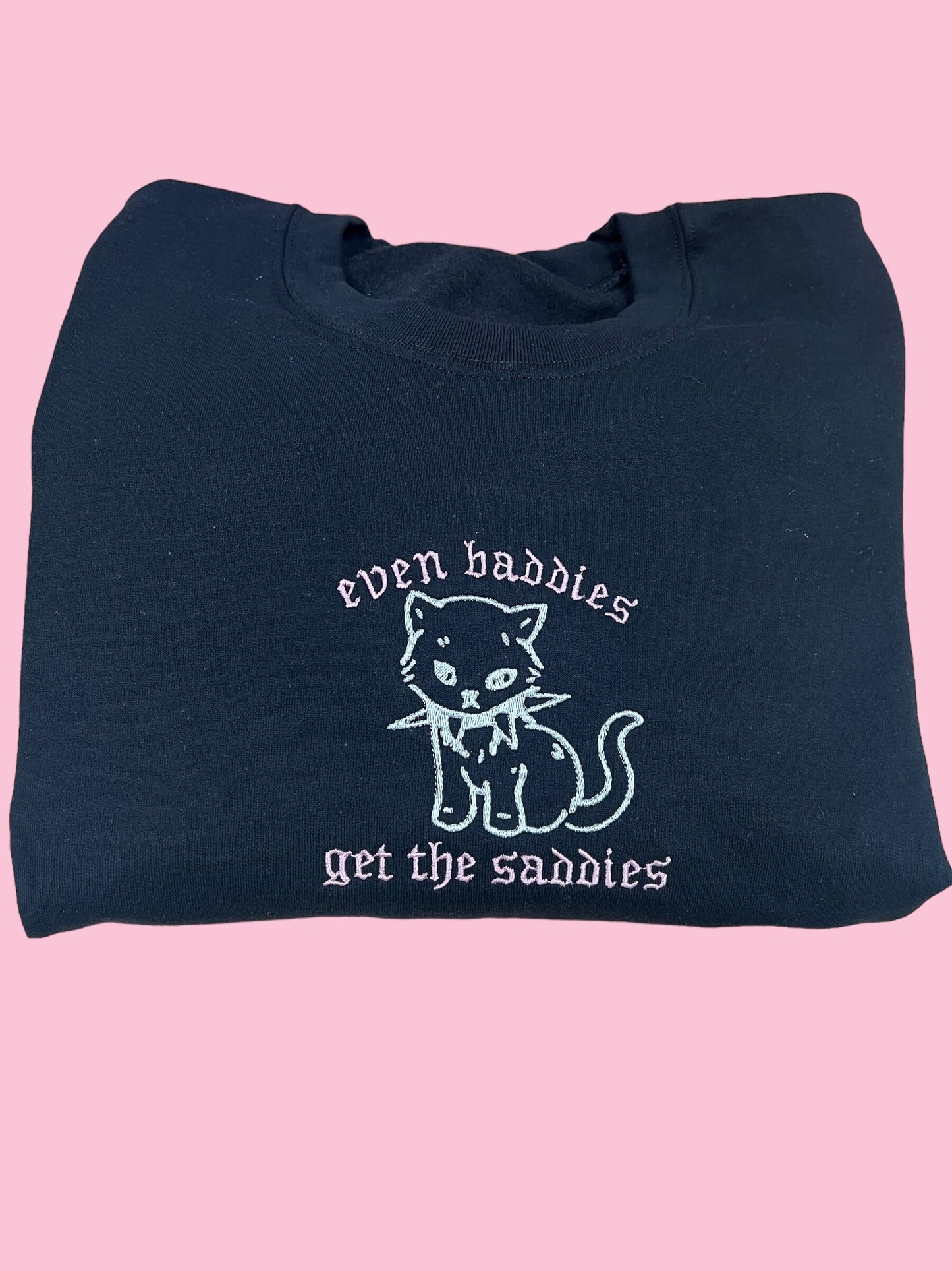 a black bag with a white cat on it