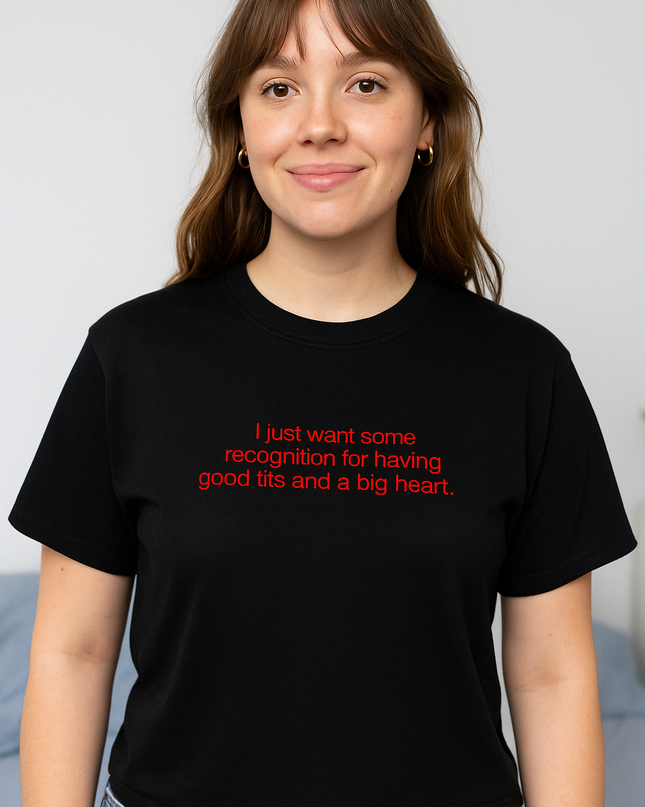 A woman wearing a black t-shirt with text on it, smiling at the camera.