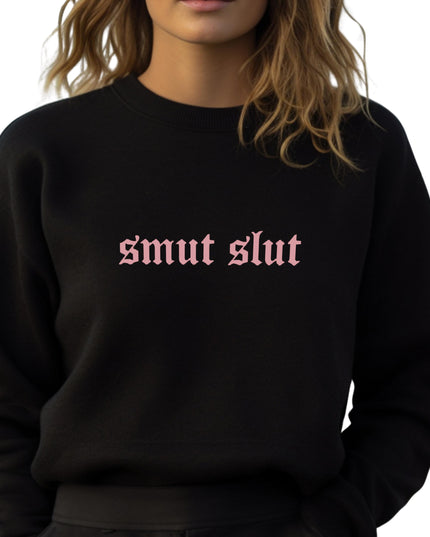 a woman wearing a black sweatshirt with the word smut slut printed on it