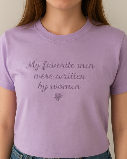 a woman wearing a purple shirt that says, my favorite men were written by women
