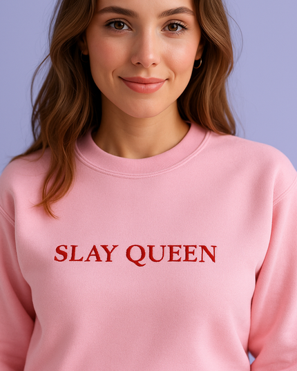 A woman wearing a pink sweatshirt with the text "SLAY QUEEN" printed on it.