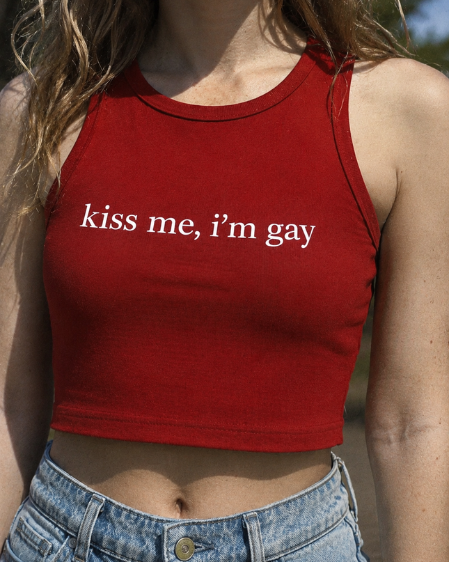 A woman wearing a red crop top with the text "kiss me, i'm gay" printed on it.