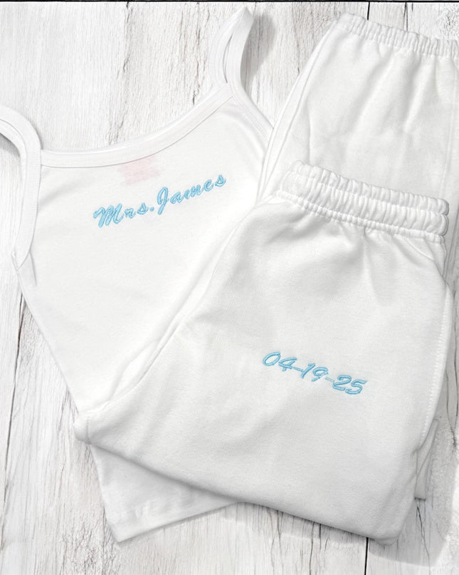 two white onesuits with blue writing on them