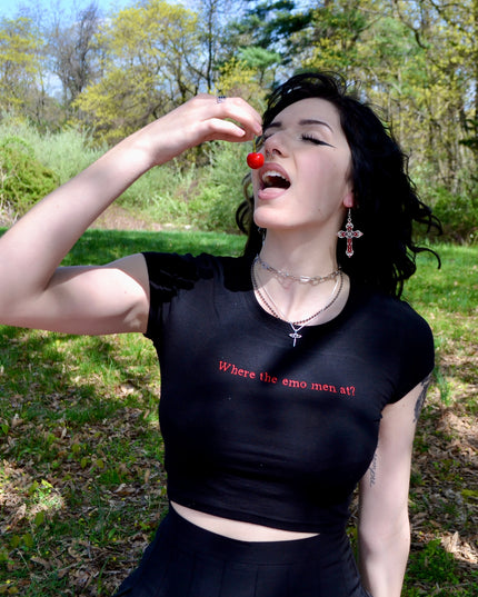 a woman in a black shirt is holding a red object
