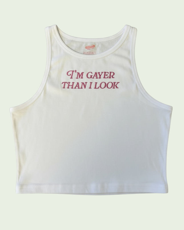 A white crop top with the text "I'm Gayer Than I Look" printed on it.