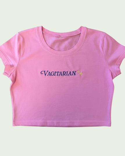 A pink crop top with the text "Vagitorian" embroidered on it.