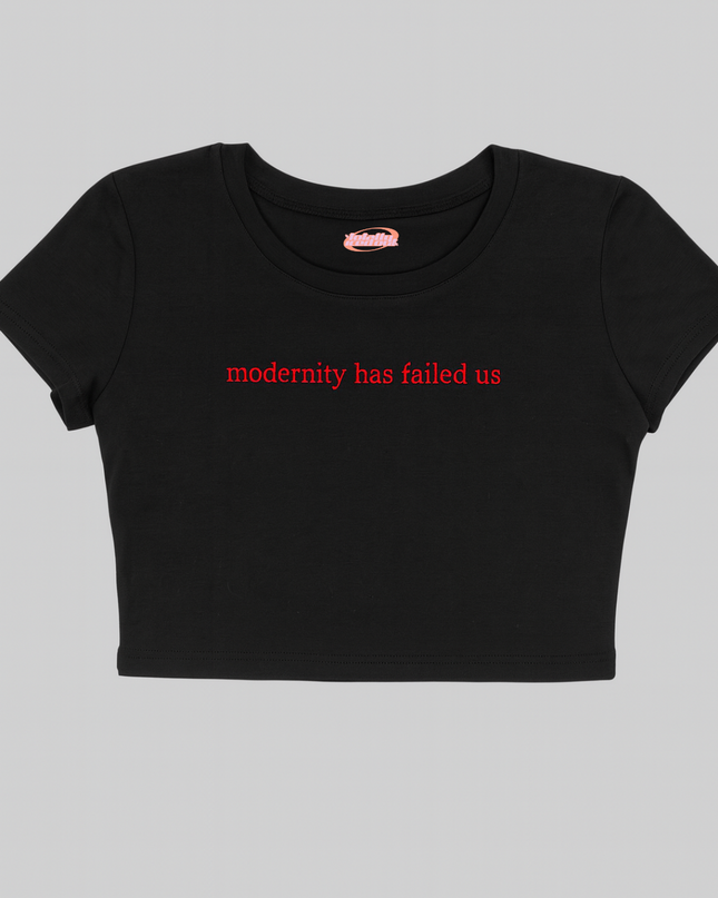 A black crop top with the text "modernity has failed us" printed on it.