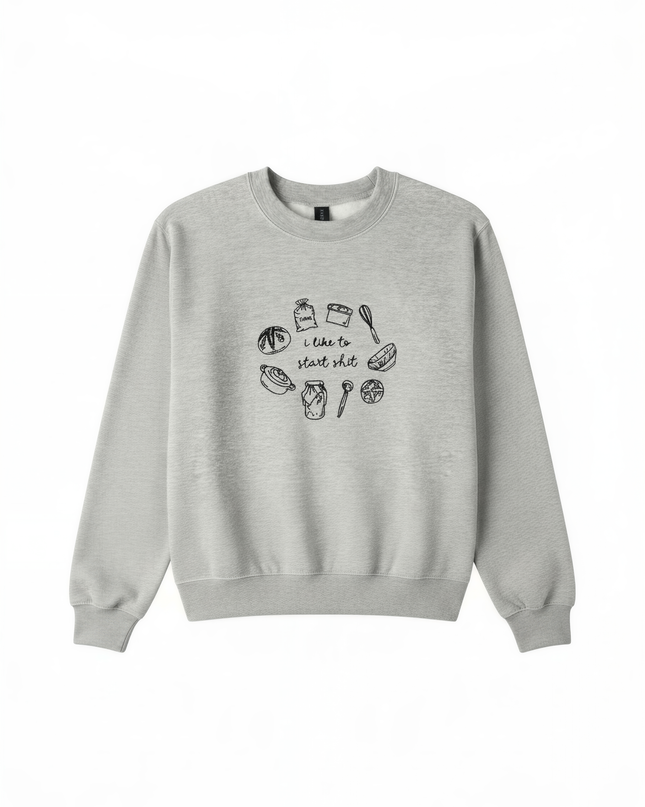 A gray sweatshirt with a graphic design featuring various kitchen utensils and ingredients, along with the text "I took to the stove to make some shit".
