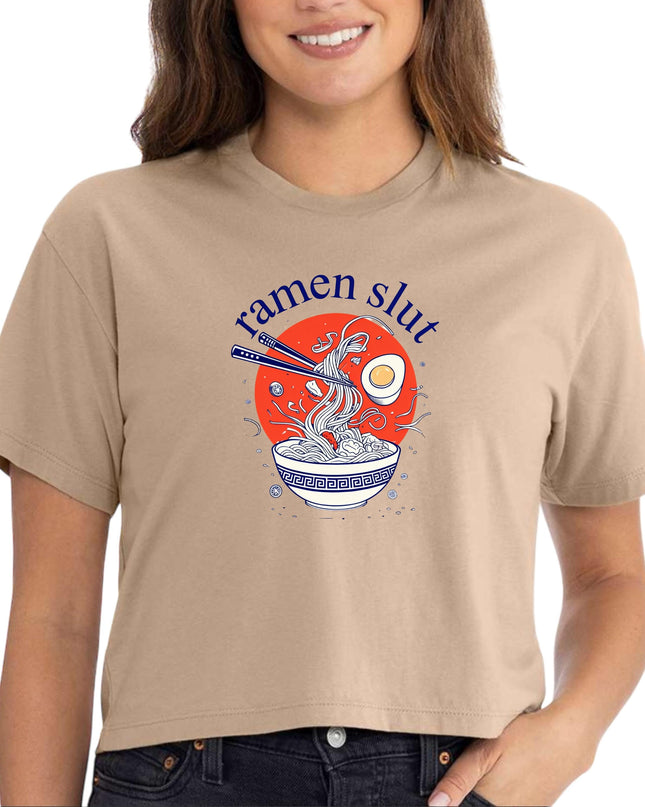 a woman wearing a tan t - shirt that says ramen slut