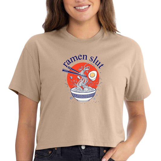 a woman wearing a tan t - shirt that says ramen slut