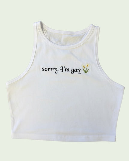 A white crop top with the text "Sorry I'm gay" embroidered on it.