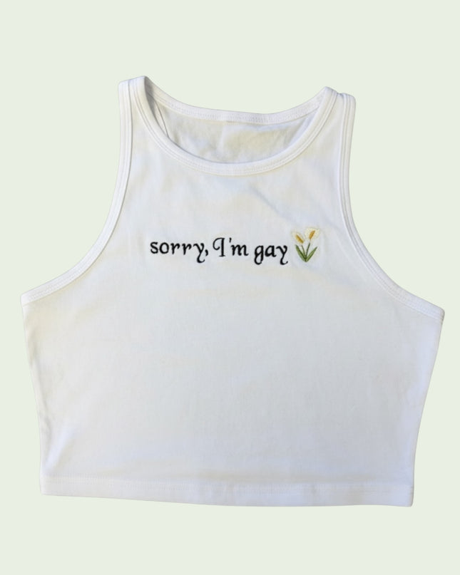 A white crop top with the text "Sorry I'm gay" embroidered on it.