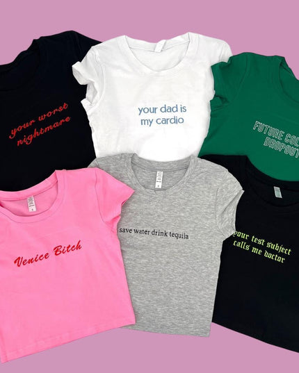 a group of t - shirts that are on a pink background