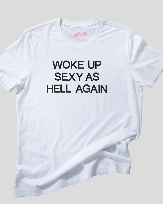 A white t-shirt with the text "Woke up sexy as hell again" printed on it.