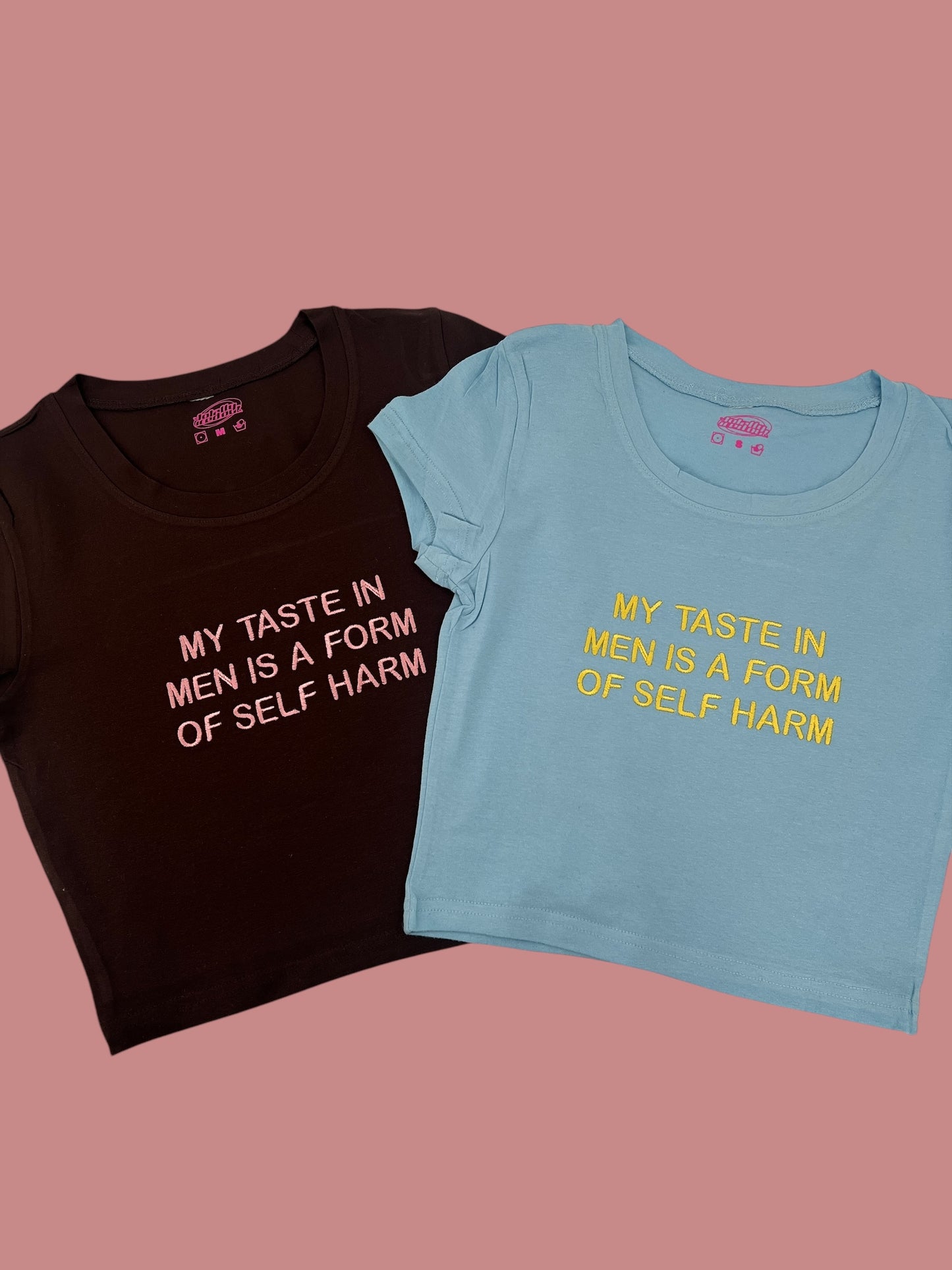 Two t-shirts with the same text printed on them, one in black and one in blue.