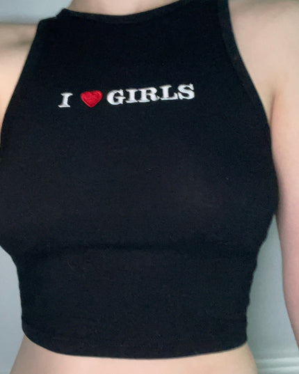 a woman wearing a black crop top that says i love girls