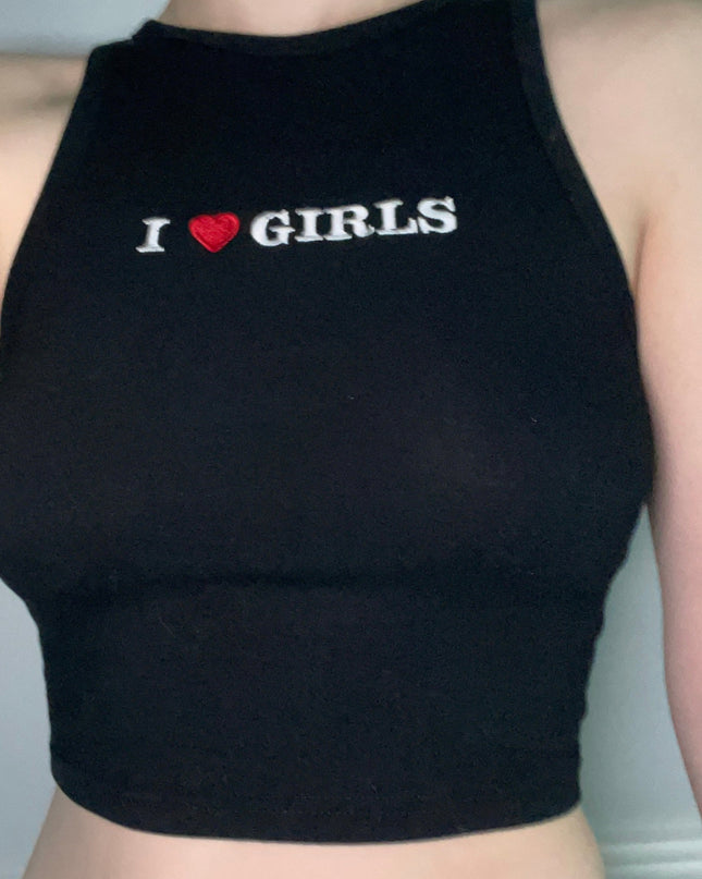 a woman wearing a black crop top that says i love girls