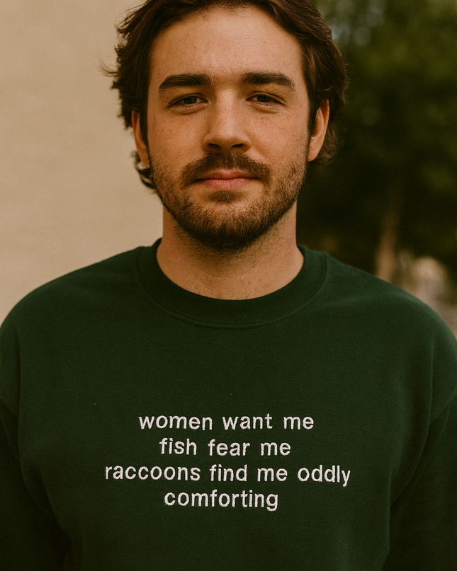 A man wearing a green sweatshirt with white text on it.