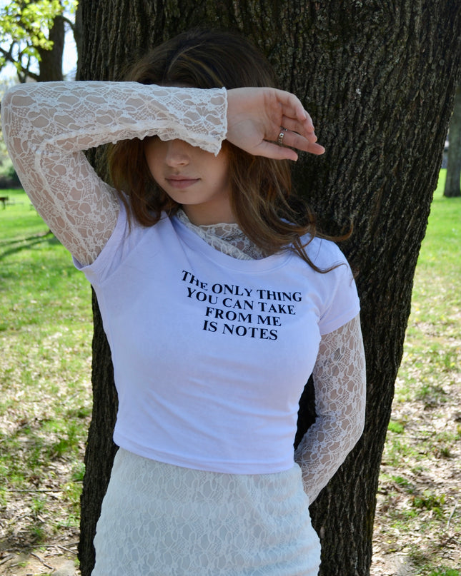 a woman standing next to a tree with her hands on her head
