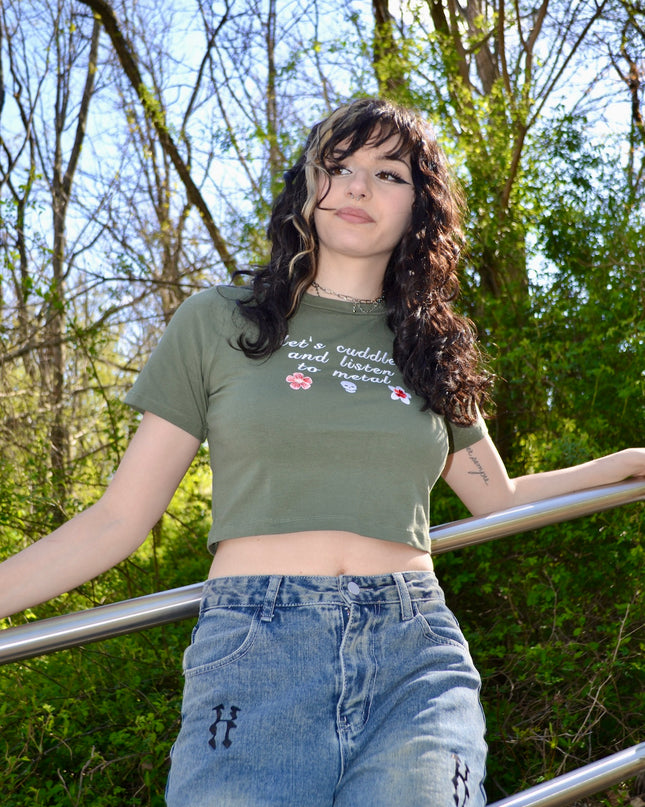 a woman in a green shirt leaning on a rail