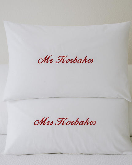 a couple of pillows sitting on top of a bed