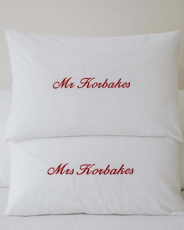 a couple of pillows sitting on top of a bed