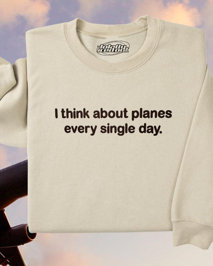 a white sweatshirt with the words i think about planes every single day