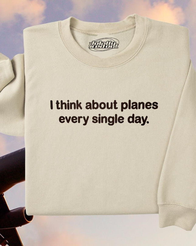 a white sweatshirt with the words i think about planes every single day