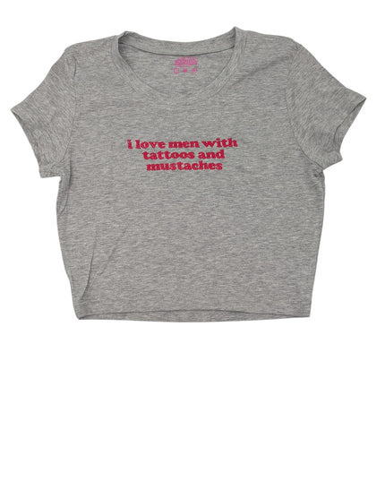 A gray t-shirt with the text "I love men with tattoos and mustaches" printed on it in red.
