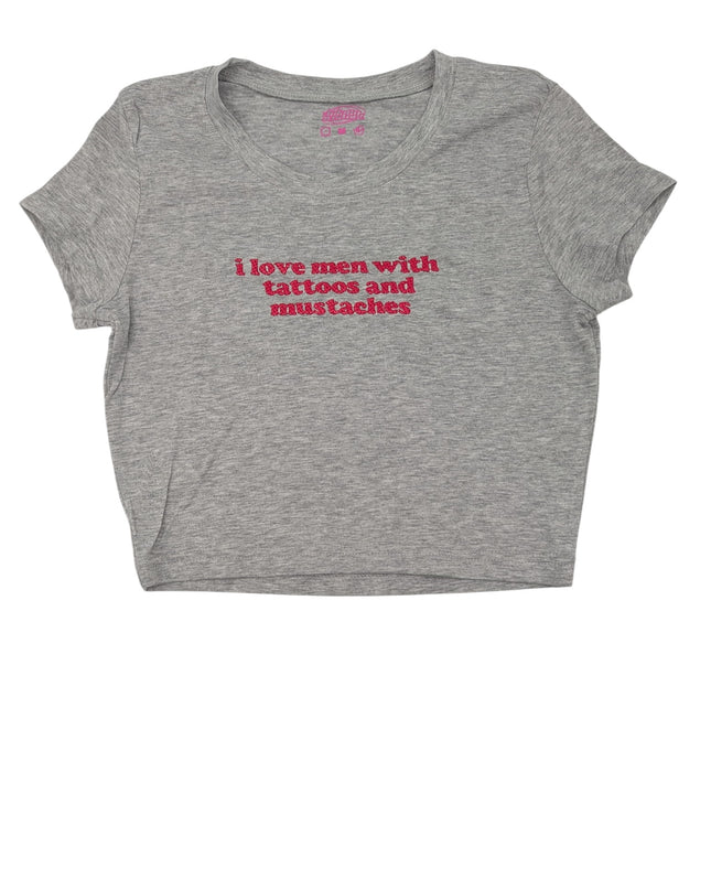 A gray t-shirt with the text "I love men with tattoos and mustaches" printed on it in red.