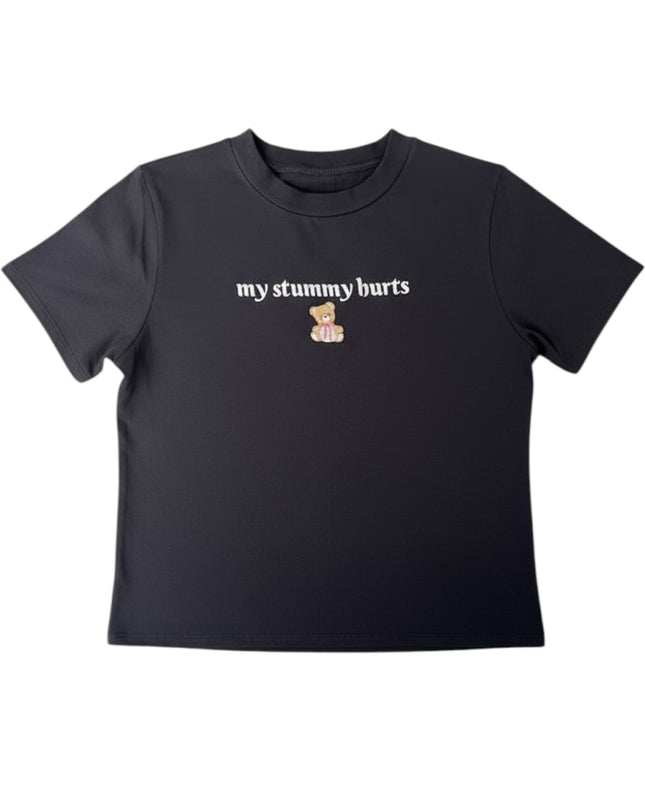 A black t-shirt with the text "my tummy hurts" printed on it.