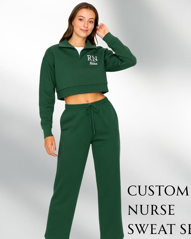 A woman wearing a green crop top and matching sweatpants, posing for a photograph.