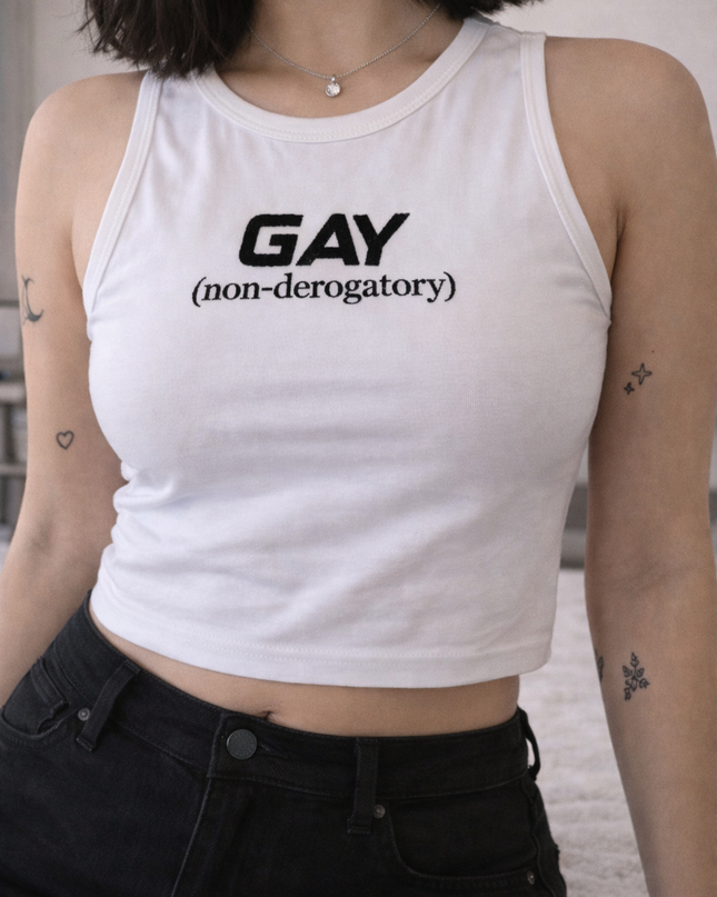 A person wearing a white crop top with the text "GAY (non-derogatory)" printed on it.