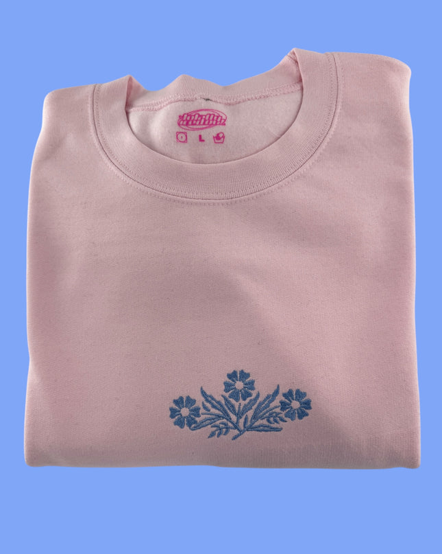 a pink shirt with blue flowers on it