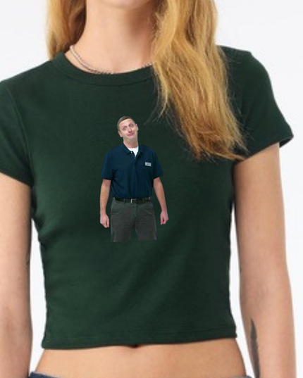 A woman wearing a green shirt with a small image of a man printed on it.