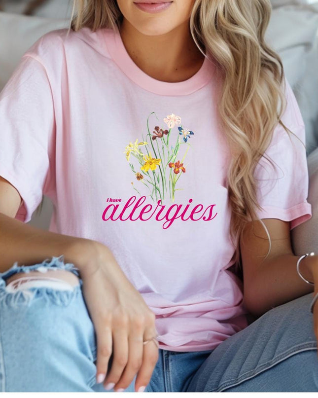 a woman sitting on a couch wearing a pink shirt