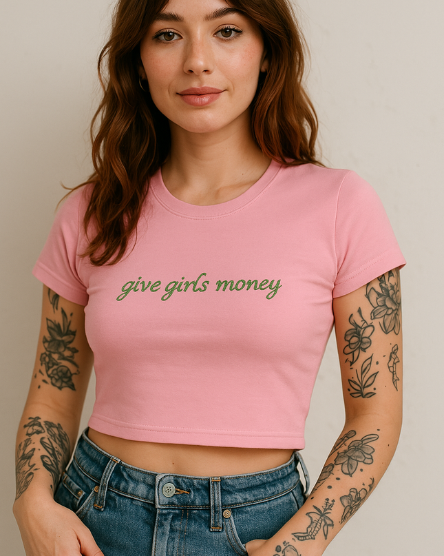 a woman wearing a pink crop top with the words give girls money on it