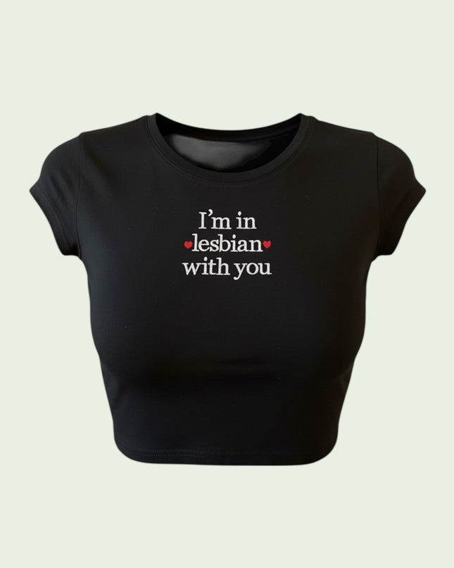 A black crop top with white text that reads "I'm in Lesbian with you".